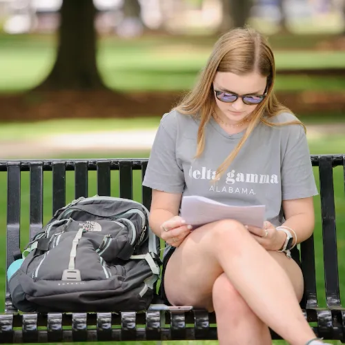 Student studying on the quad